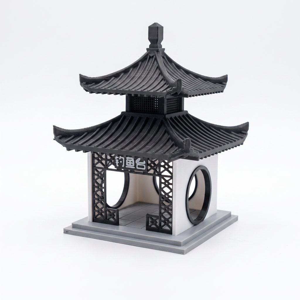 A miniature black and gray pagoda-style decorative structure with curved tiled roofs, lattice side panels, circular openings, and a base, photographed on a clean white studio background.