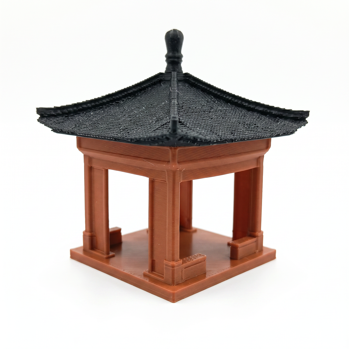 A miniature traditional-style pagoda or pavilion model with a black tiled roof and reddish-brown wooden structure, shown on a plain white background. Aquarium decoration and terrarium decoration.
