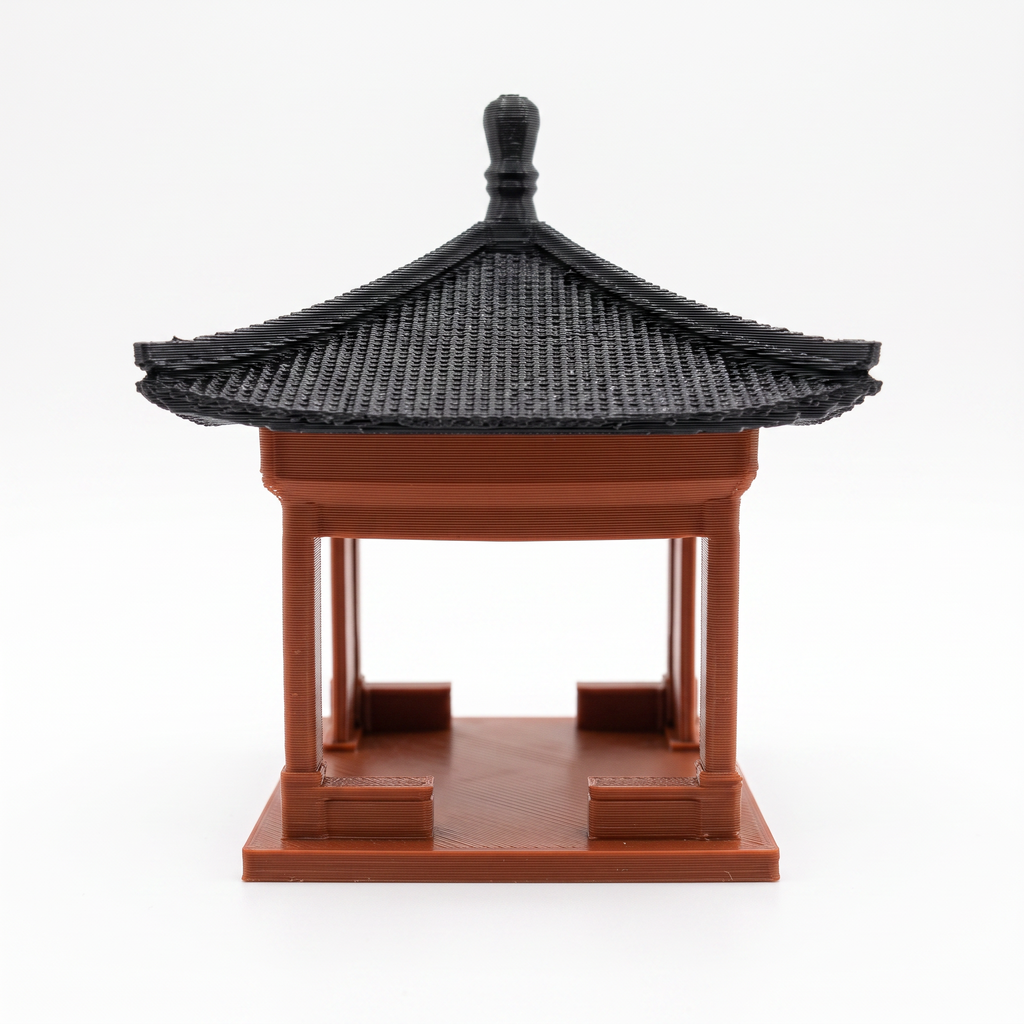 A miniature 3D-printed model of a traditional East Asian pavilion or pagoda with a black tiled roof and reddish-brown wooden structure, shown on a plain white background.